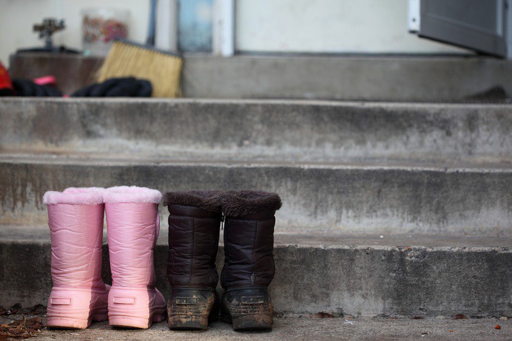 A pair of boots sitting on top of concrete steps.