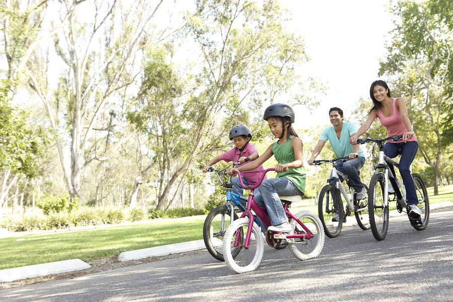 A family riding bikes down the street