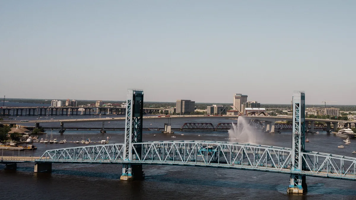The blue Main Street Bridge over the St. Johns River in downtown Jacksonville, Florida, on a clear, sunny day